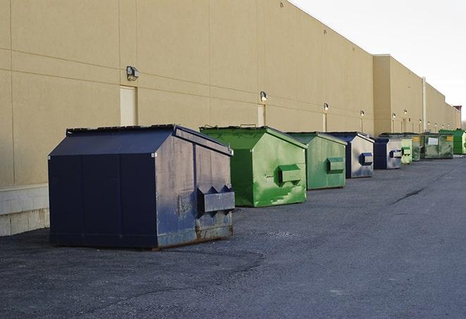 a row of industrial dumpsters at a construction site in Central Valley